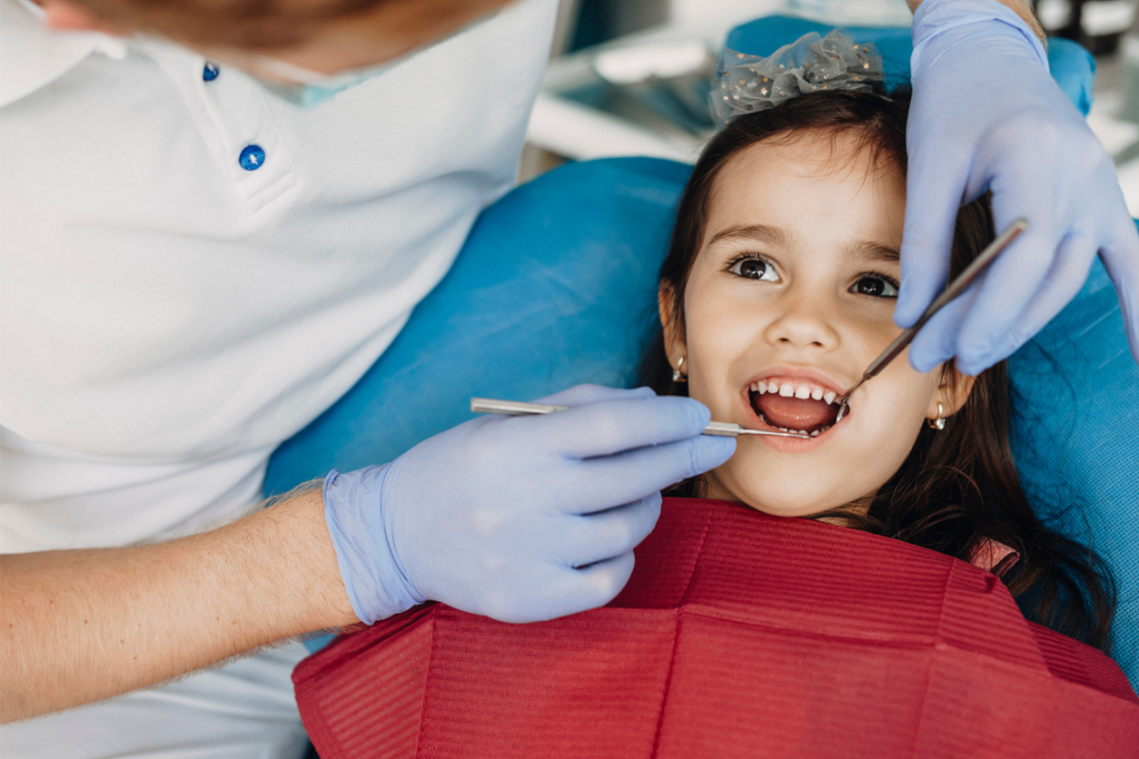 kids dentist at Smile Town Dental Group examining child's teeth
