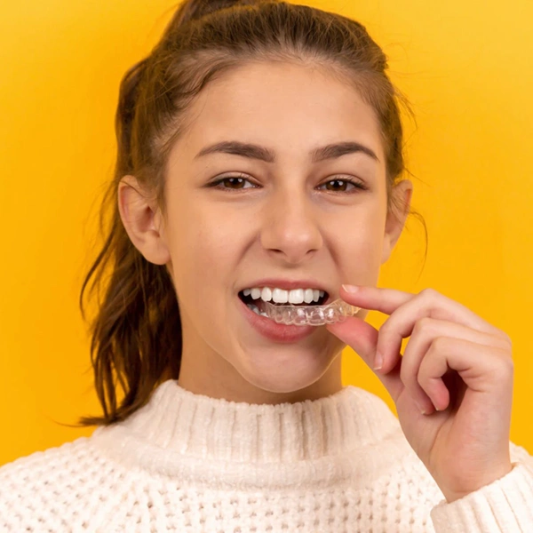 teenager putting in invisible clear aligners
