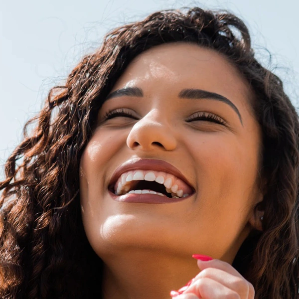 adult woman smiling and laughing outdoors