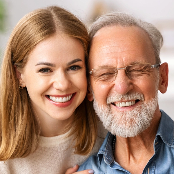 adult daughter and father smiling