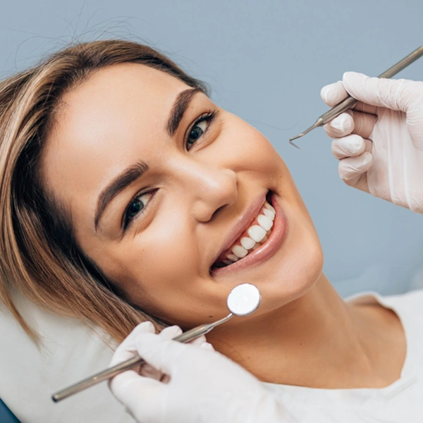 woman in patient chair with great teeth smiling
