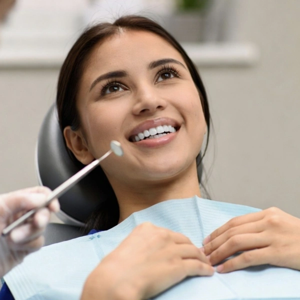 smiling woman in patient chair at dentist