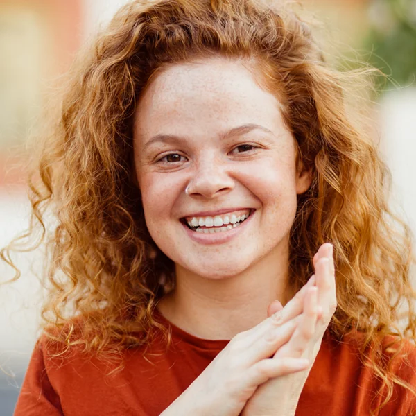 young woman with red hair smiling