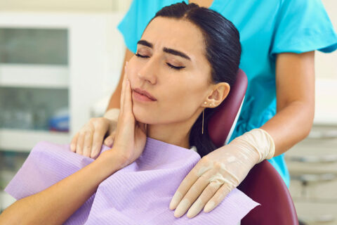 A women having a tooth ache and a dentist's office