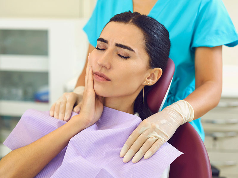 A women having a tooth ache and a dentist's office